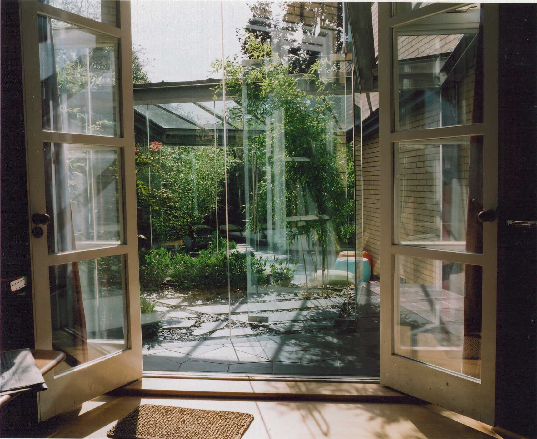 Frameless glass extension onto garden patio, Dartmouth park, London.