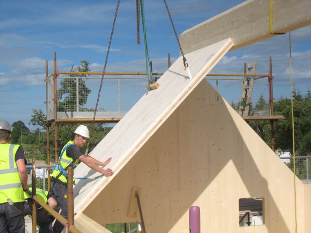 Workman building roof of Flower House - Scotland’s Housing Expo winner for state-of-the-art sustainable housing.
