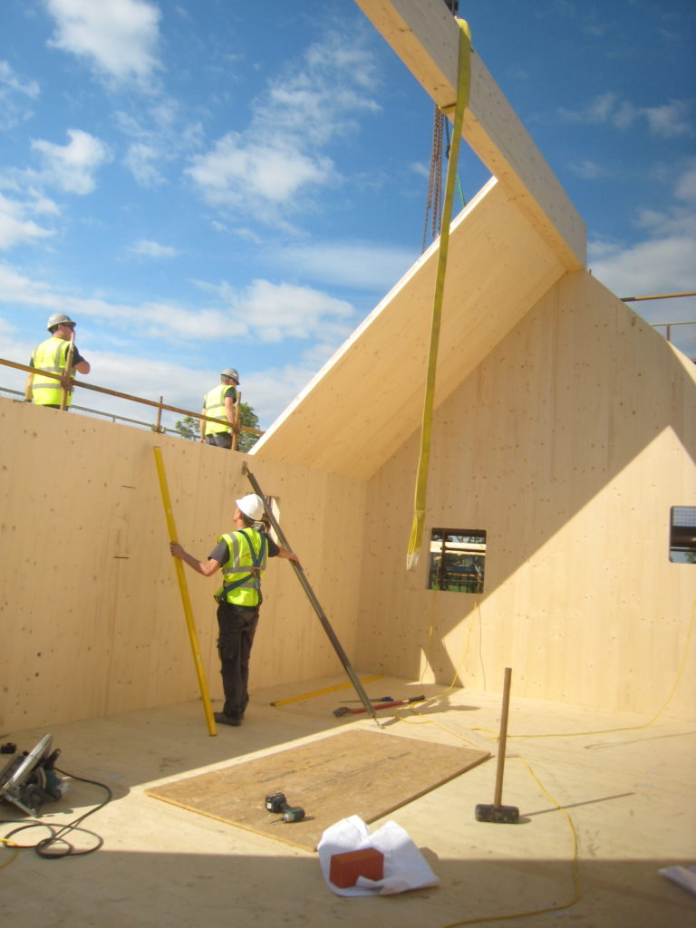 Workman building roof of Flower House - Scotland’s Housing Expo winner for state-of-the-art sustainable housing.