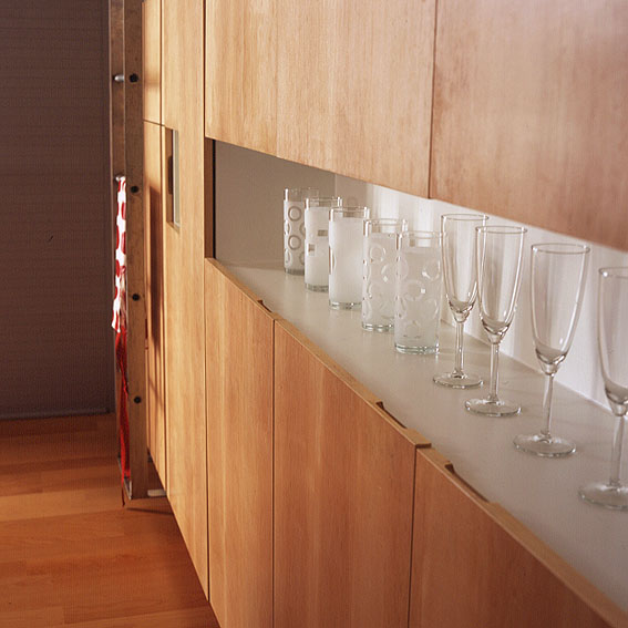 Wooden kitchen cupboards and glass display.